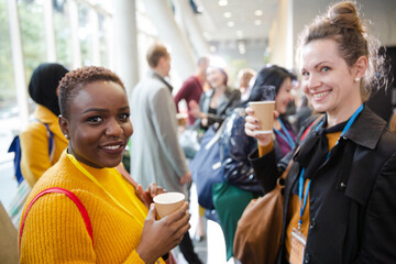 Women drinking coffee during conference break