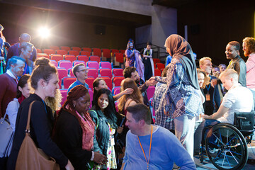 Fototapeta na wymiar Female speaker in hijab on stage talking to audience