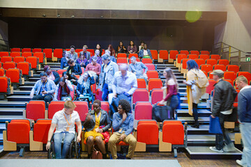 Audience arriving and sitting in auditorium