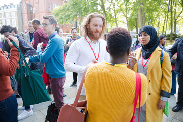People talking outside auditorium