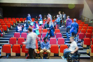 Audience arriving and sitting in auditorium