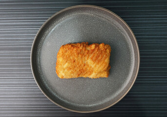 deep fried golden chicken chop cutlet fish fillet on dark grey wood background dim sum halal menu