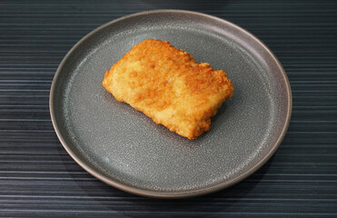 deep fried golden chicken chop cutlet fish fillet on dark grey wood background dim sum halal menu