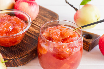 thick jam with apple slices in a jar and bowl. vitamin dessert.
