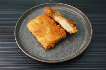 deep fried golden chicken chop cutlet fish fillet on dark grey wood background dim sum halal menu