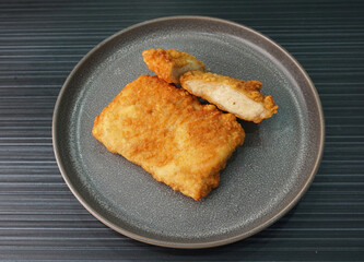 deep fried golden chicken chop cutlet fish fillet on dark grey wood background dim sum halal menu