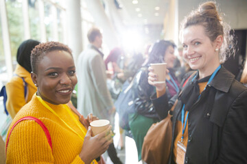 Women drinking coffee during conference break
