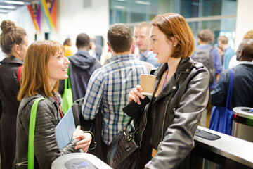 Smiling businesswomen in conference audience
