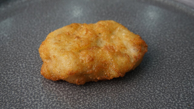deep fried golden chicken nugget fritter with sauce on dark grey wood background dim sum halal menu