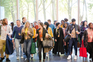People walking down auditorium hall