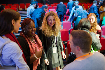 Audience talking to speakers in wheelchairs on stage