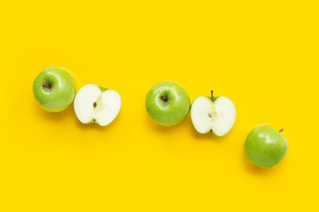 Green apples on yellow background.