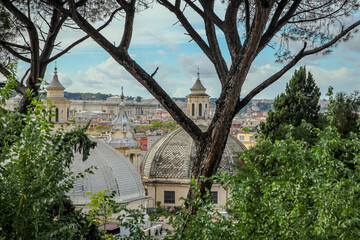 Fototapeta na wymiar View of Rome, St. Peter's Cathedral, the Altar of the Fatherland and other attractions from the Pincio hill. Rome, Italy