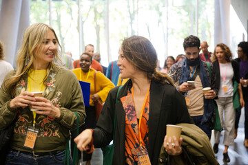 People walking down auditorium hall