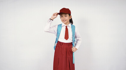 asian little girl wearing hat and school bag smiling happily on white background isolated