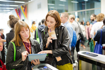 Businesswomen in conference audience using digital tablet