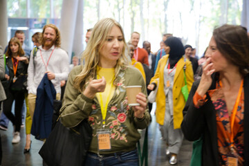 People walking down auditorium hall