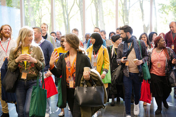 People walking down auditorium hall