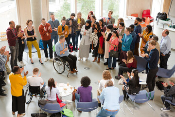 Speaker in wheelchair talking to conference audience