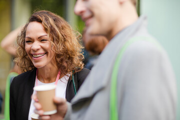 People holding coffee cups during conference break