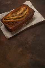 Ready fresh banana bread in rectangular shape on dark background