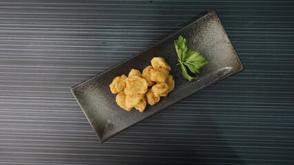 deep fried golden fish prawn ball seafood in dry or soup bowl on dark grey wood background dim sum...