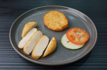 deep fried golden big fish prawn cake ball seafood in round shape on dark grey wood background asian dim sum halal food restaurant cuisine banquet menu for cafe