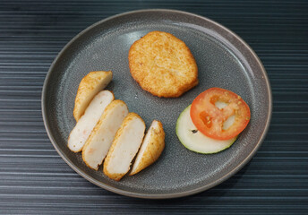 deep fried golden big fish prawn cake ball seafood in round shape on dark grey wood background dim sum halal menu
