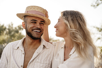 Young couple sitting next to each other on beach