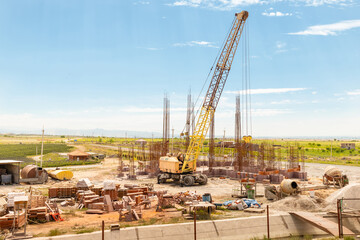 construction site with mobile crane on wheels and armature rods