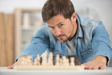man studying the next chess move