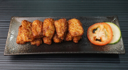 deep fried pork fish meat roll wrapped with bean curd skin ngohiang on dark grey wood background dim sum menu