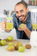 Fototapeta premium young man preparing fresh vitamin summer juice