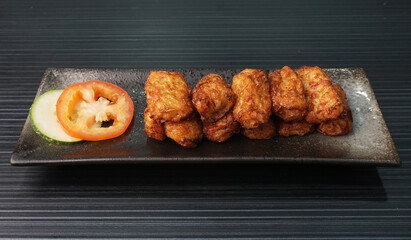 deep fried pork fish meat roll wrapped with bean curd skin ngohiang on dark grey wood background dim sum menu