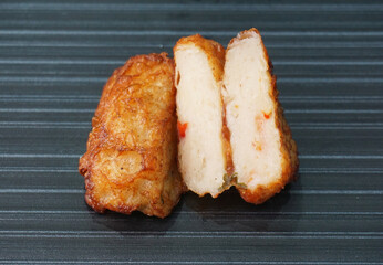 deep fried pork fish meat roll wrapped with bean curd skin ngohiang on dark grey wood background dim sum menu