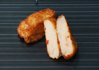 deep fried pork fish meat roll wrapped with bean curd skin ngohiang on dark grey wood background dim sum menu