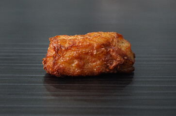 deep fried pork fish meat roll wrapped with bean curd skin ngohiang on dark grey wood background dim sum menu
