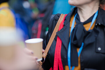 People holding coffee cups during conference break