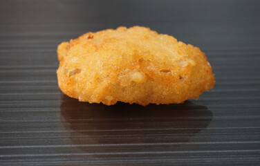 Japanese crispy deep fried tatsuta chicken nugget on dark grey wood background dim sum halal menu