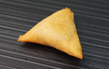 deep fried crispy yam taro spring roll samosa on dark grey wood background dim sum halal menu