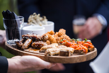 Delicious grilled bbq meet food platter with pork sausages dips and appetisers at wedding reception...