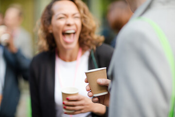 People holding coffee cups during conference break