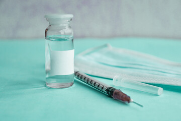 vaccine on a vial bottle and injection Syringe on a white table