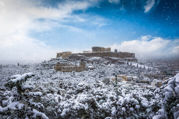 Winter view to the Parthenon Temple at the Acropolis of Athens, Greece, with thick snow and cloudy...