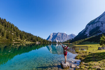 woman enjoying beauty of nature looking at mountain. Adventure travel, Europe. Woman stands on background with Alps.