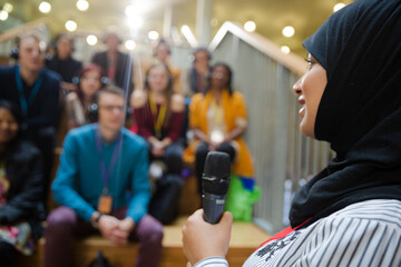 Female speaker in hijab talking to audience