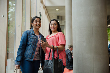 Two businesswoman walking in conference hall
