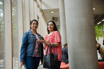 Two businesswoman walking in conference hall