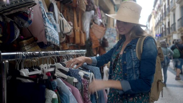 young woman tourist buying souvenir