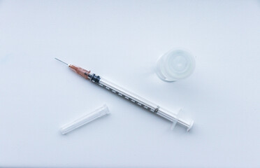 vaccine on a vial bottle and injection Syringe on a white table